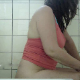 A brunette woman takes a shit and smokes a cigarette while sitting on a toilet. She shows us her dirty ass and wipes.